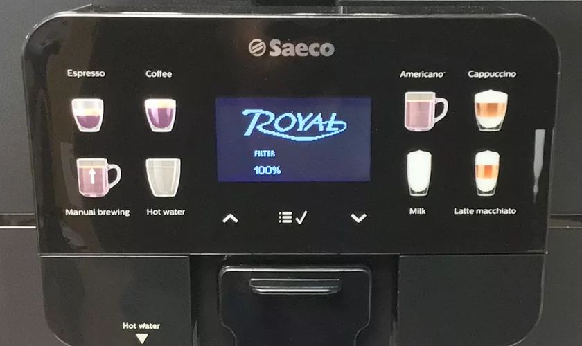 A close-up of the DISCONTINUED Saeco New Royal OTC Super-Automatic Espresso Machine display highlights options like espresso, coffee, americano, cappuccino, manual brewing, hot water, milk, and latte macchiato on its digital screen. © 2025 1st-line.com