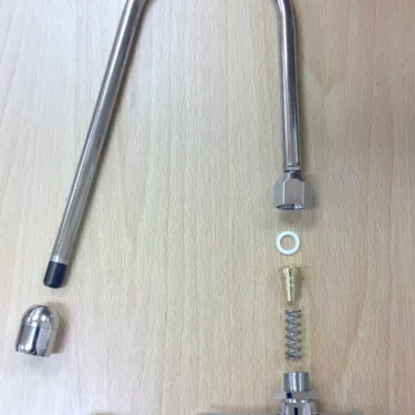 Disassembled Lelit Bianca Joystick Valves Monster Kit for Steam/Hot Water shown on a light wood surface, with metal spout, valve, wooden handle, and internal components neatly arranged in order. © 2025 1st-line.com