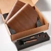 Open cardboard box with the VBM WOODENKITDS Domobar Super Wood Kit: two wooden boards, foam insert with metal and wood-handled scoop, two round wooden pieces, and a small wooden stick. © 2025 1st-line.com