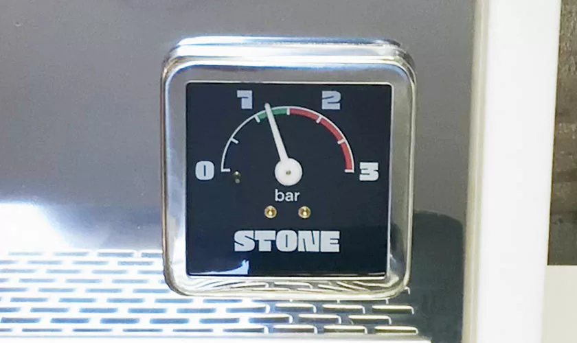 A close-up of the pressure gauge on the Stone HX Espresso Machine displays a 0–3 bar scale. The needle hovers just above 1 bar, with STONE printed at the bottom of the gauge. © 2025 1st-line.com