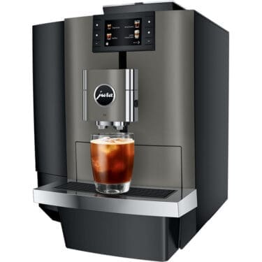 The Jura GIGA 10 Super-Automatic Espresso Machine, with digital controls and a metallic finish, dispenses iced coffee into a clear glass. © 2025 1st-line.com