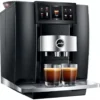 The sleek black and silver Jura GIGA 10 Super-Automatic Espresso Machine brews two espressos, with a digital touchscreen showcasing multiple coffee options above the cups. © 2025 1st-line.com