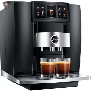 The sleek black and silver Jura GIGA 10 Super-Automatic Espresso Machine brews two espressos, with a digital touchscreen showcasing multiple coffee options above the cups. © 2025 1st-line.com