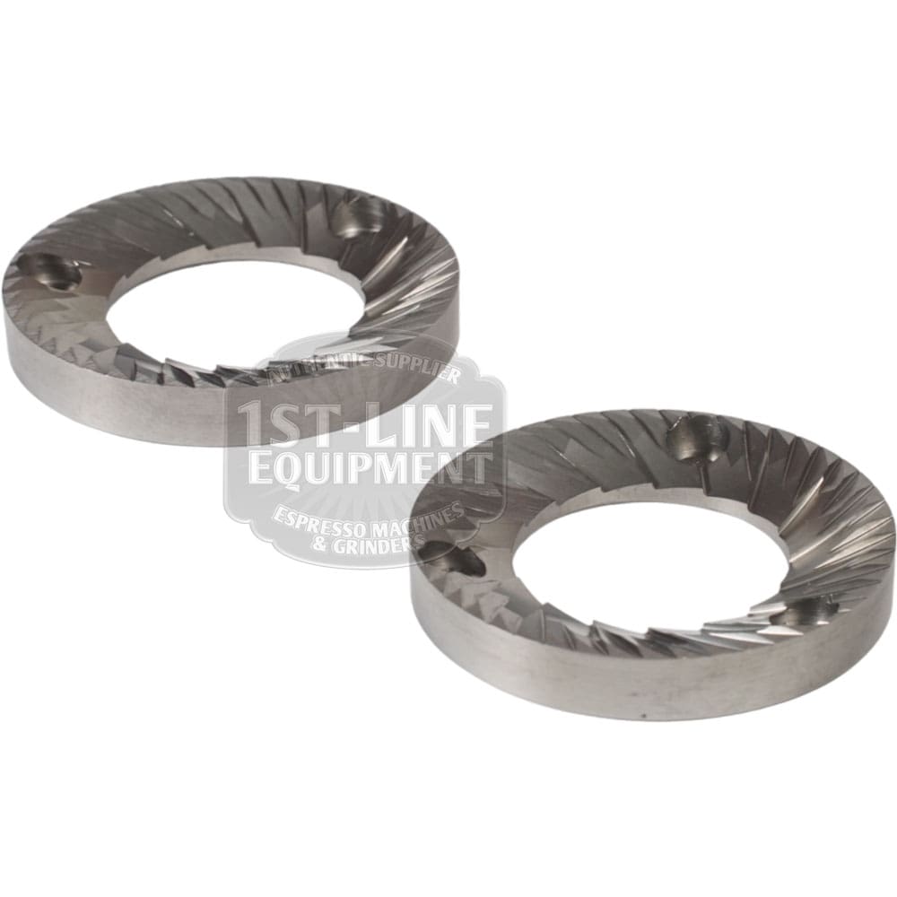 A set of two Quamar 260017 54 mm Q50 Grinding Burrs with sharp angled edges and mounting holes is displayed on a white background. © 2025 1st-line.com