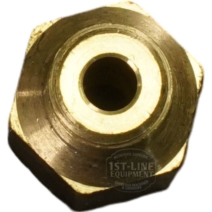 Close-up of a Bezzera 5302085 Fitting 1/8GF x 1/8GC, a brass hexagonal fitting with a central hole, viewed from above on a white background. The faint 1st-Line Equipment logo appears in the bottom right corner. © 2025 1st-line.com