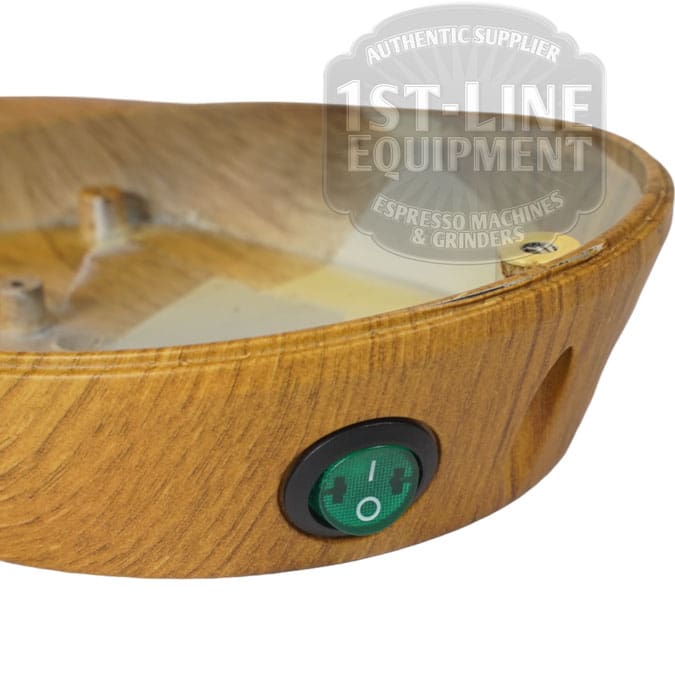 Close-up of the Quamar 160435 Wood Effect Bottom featuring a green power switch. The 1st-Line Equipment, Espresso Machines & Grinders, Authentic Supplier logo appears in the upper right corner. © 2025 1st-line.com