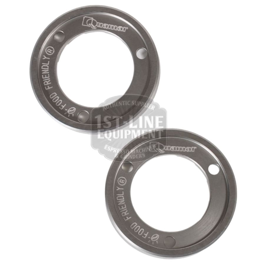 The Quamar 260015 63 mm Grinding Burrs, set of 2, are circular burrs each with two mounting holes and engraved with Quamar and FOOD FRIENDLY, shown on a white background. © 2025 1st-line.com
