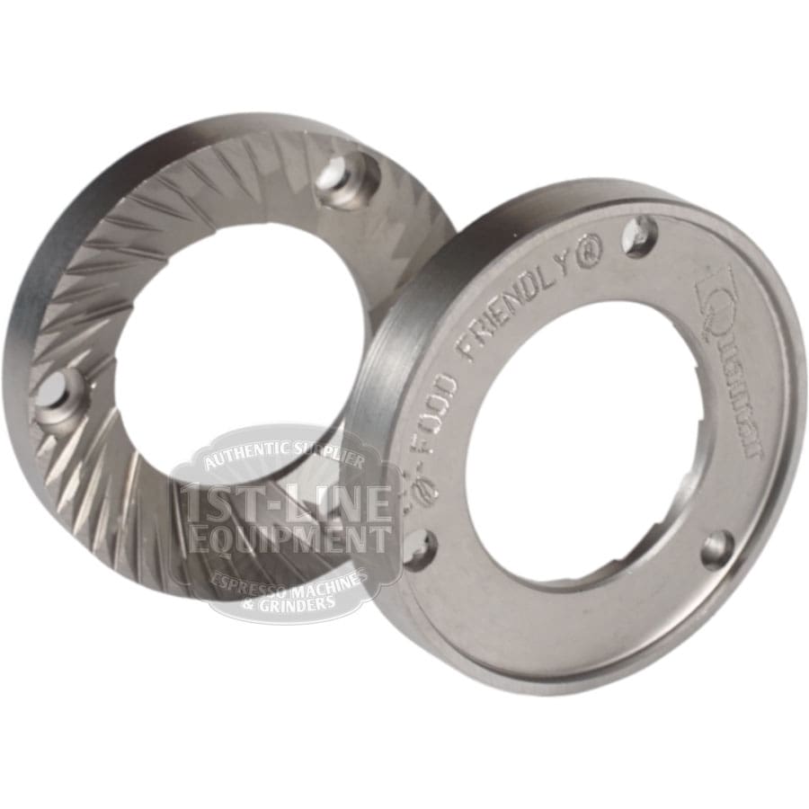 The Quamar 260017 54 mm Q50 Grinding Burrs - Set of 2 includes one serrated and one flat upright silver burr, both ideal replacement parts for Q50 grinders. The serrated burr has sharp grooves; the flat one is engraved with text. © 2025 1st-line.com