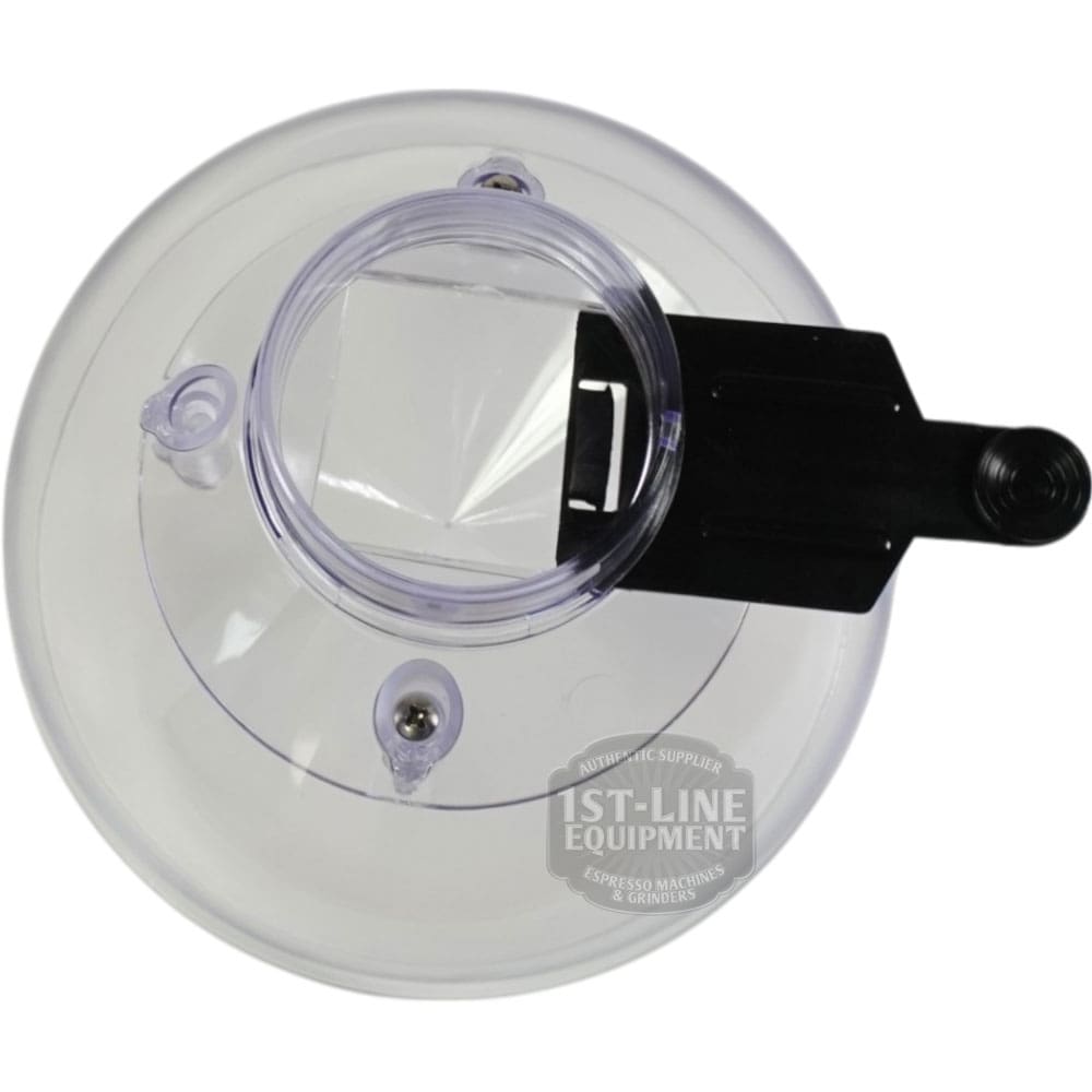 Top view of a clear, round plastic lid with a square opening, black handle, and two screw holes, designed for the Quamar RMM800008 500 G Bean Hopper Assembly; features 1st-Line Equipment watermark. © 2025 1st-line.com