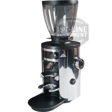 The Mahlkonig X54 Allround Home Grinder features a shiny chrome finish, clear bean hopper, side black knob, front portafilter holder, and a transparent 1st Line Equipment label—ideal for home coffee grinding.