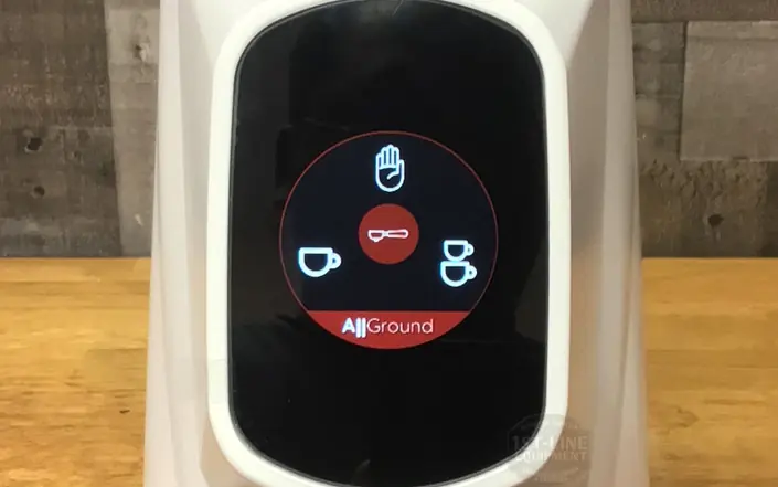 A close-up of the Fiorenzato All Ground Sense Coffee Grinder - Weight-Based Grinding control panel, showing icons for single cup, double cup, hands-free mode, and stop hand on a wooden background. © 2025 1st-line.com