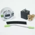 A digital control dial, brass and black solenoid valve, foam strip, and gray cable with green connectors from the Lelit 4000061 Bianca V2 to V3 Conversion Kit are arranged on a white surface. © 2025 1st-line.com