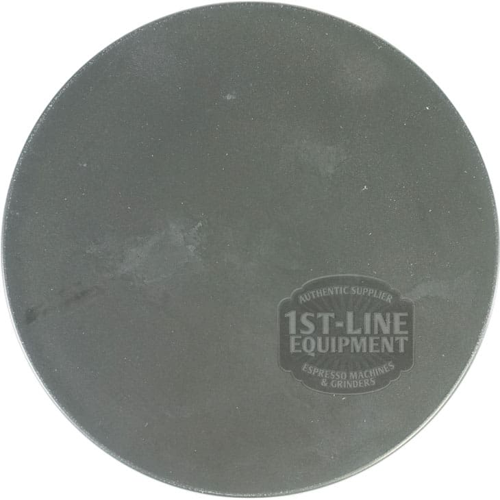 A round, flat, dark gray tamping mat with the 1st-Line Equipment logo printed on the lower right—perfect for use alongside your Pinecone PIN90001 Bean Hopper Lid. © 2025 1st-line.com