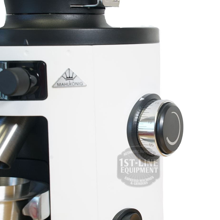 Close-up of a white Mahlkonig X54 Allround Home Grinder, featuring its adjustment dial, bean hopper, and metal grounds container. The 1st-Line Equipment logo is visible on this versatile home grinder. © 2025 1st-line.com