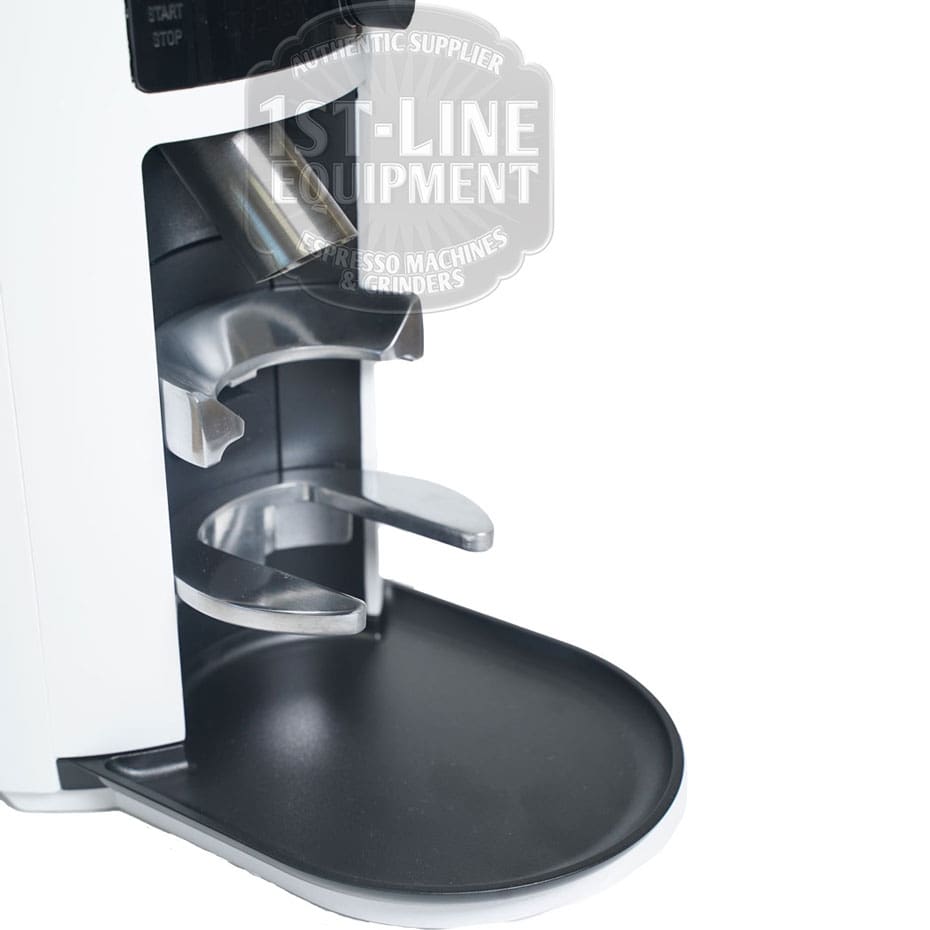 Close-up of the Mahlkonig X54 Allround Home Grinder in white, featuring a metal portafilter holder, black drip tray, and front-facing control buttons with visible branding. © 2025 1st-line.com