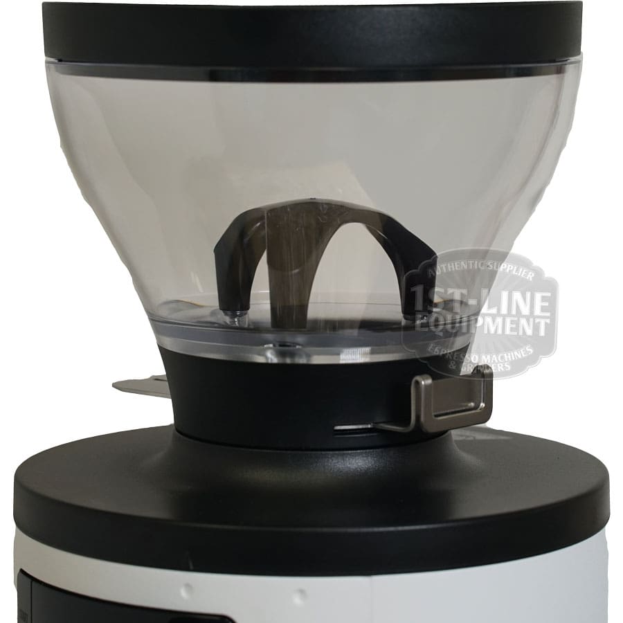 Close-up of the Mahlkonig X54 Allround Home Grinders transparent hopper with black lid and metal latch, featuring a “1st-Line Equipment” logo. The hopper is mounted on top of the grinder for home use. © 2025 1st-line.com