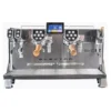 The Elektra Evok 2 Group Commercial Espresso Machine features a stainless steel body, two group heads with wooden handles, a central touchscreen, multiple control buttons, and EVO model branding on the front. © 2025 1st-line.com