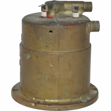 The Rancilio 20102944 230V Boiler features a cylindrical brass body with a welded element on top, two threaded pipe connections, electrical terminals, and base mounting holes for vintage aviation applications. © 2025 1st-line.com