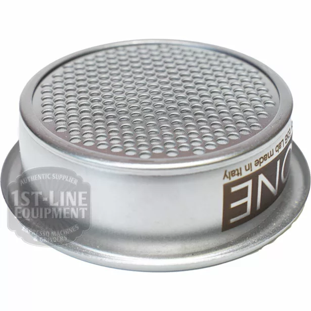 The E&B Lab B702TH22/ONE All-in-One Filter Basket is a metal espresso portafilter basket with a perforated surface, designed to hold coffee grounds during brewing. Made in Italy and the logo are partially visible on the basket. © 2025 1st-line.com