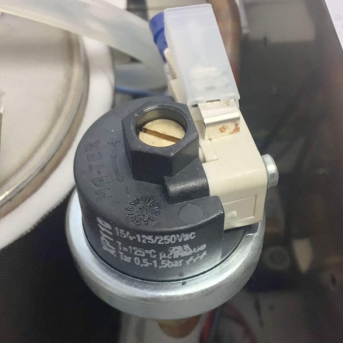 Close-up of a black and gray 15A 125/250VAC electrical component with wires and connector, mounted inside the Nurri R-Type SB (HX) Espresso Machine. © 2025 1st-line.com