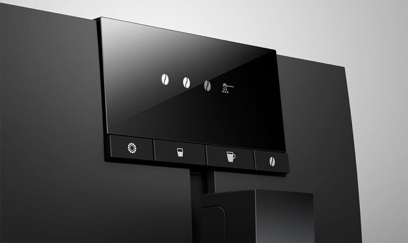 Close-up of the Jura ENA 4 Super-Automatic Espresso Machines sleek black display panel featuring touch buttons for settings, cup size, brewing, and coffee bean options, set against a gray background. © 2025 1st-line.com
