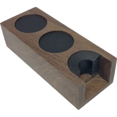 The Eureka Walnut Tamping Station - double housing is a rectangular walnut station with three circular compartments, including a partially open front section and a smooth, polished finish. © 2025 1st-line.com