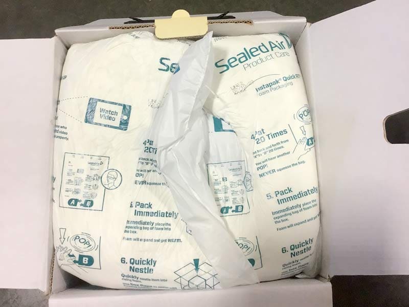 An open cardboard box containing Sealed Air brand packaging foam with how to repackaging instructions and diagrams printed on the white foam material. © 2025 1st-line.com