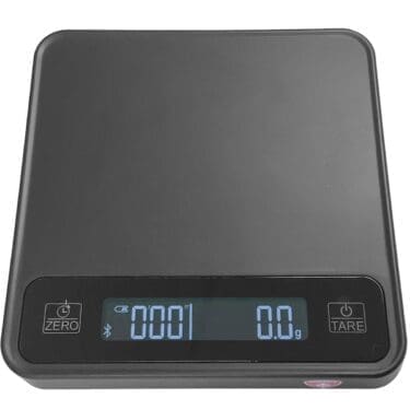 The Eureka Precisa Bluetooth Digital Scale features a black surface, illuminated display reading 000.1 grams, and ZERO and TARE buttons beside the display for precise measurements. © 2025 1st-line.com