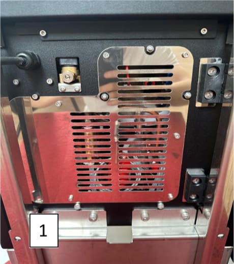 A close-up of an ACS Vesuvius metallic machine panel with ventilation slits and screws, reflecting a person wearing sneakers. A white box with the number 1 is in the bottom left corner of the image. © 2025 1st-line.com