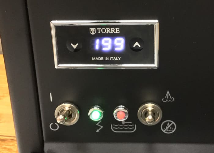 Close-up of a digital display showing 199 on the Torre Mariuccia Dual Boiler Espresso Machine w/ Flow Control, with Made in Italy beneath. Below are three switches and indicator lights for power, water, steam, and flow control. © 2025 1st-line.com