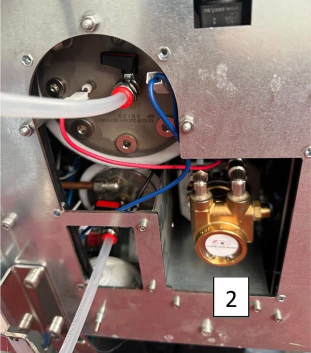 Interior view of an ACS Vostok machine showing wires, tubes, and a brass component with a gauge—essential for draining boilers. A white label with the number 2 appears in the lower right section of the image. © 2025 1st-line.com