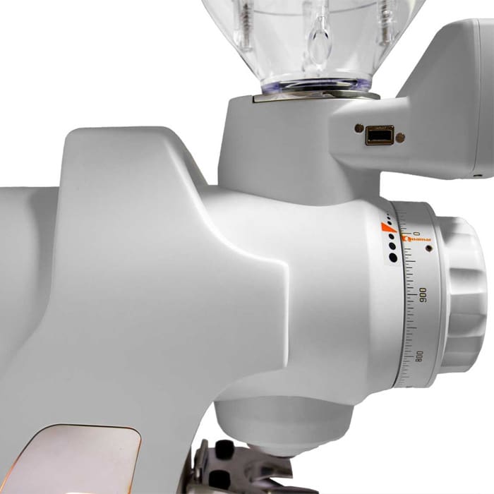 Close-up of a Quamar Sirio-Q Espresso Coffee Grinder displaying its numbered grind size adjustment dial and transparent bean hopper. A USB port is visible on the right side of the machine. © 2025 1st-line.com