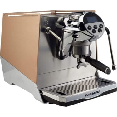 The Faema Faemina Dual Boiler Espresso Machine with AUTOSTEAM features a brushed metal and gold finish, digital display, buttons, steam wand with AUTOSTEAM, portafilter, and sits on a drip tray. © 2025 1st-line.com