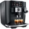 The Jura J8 Twin Super-Automatic Espresso Machine features a modern black design with metallic accents, digital display for drink options, and dual spouts dispensing two espressos into glasses on the drip tray. © 2025 1st-line.com