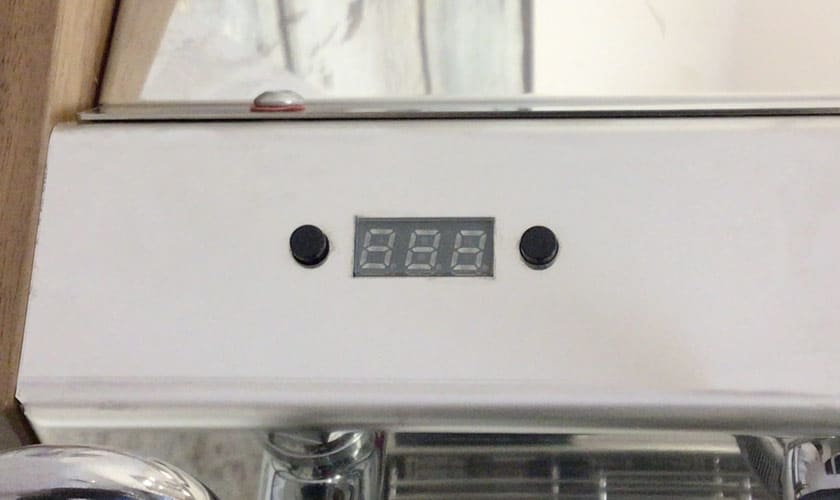 A close-up of the digital display on the Nurri L-Type Lever Leva Dual Boiler Espresso Machine shows 888, framed by two black buttons and set into the sleek metallic housing, accentuating the machine’s modern design. © 2025 1st-line.com