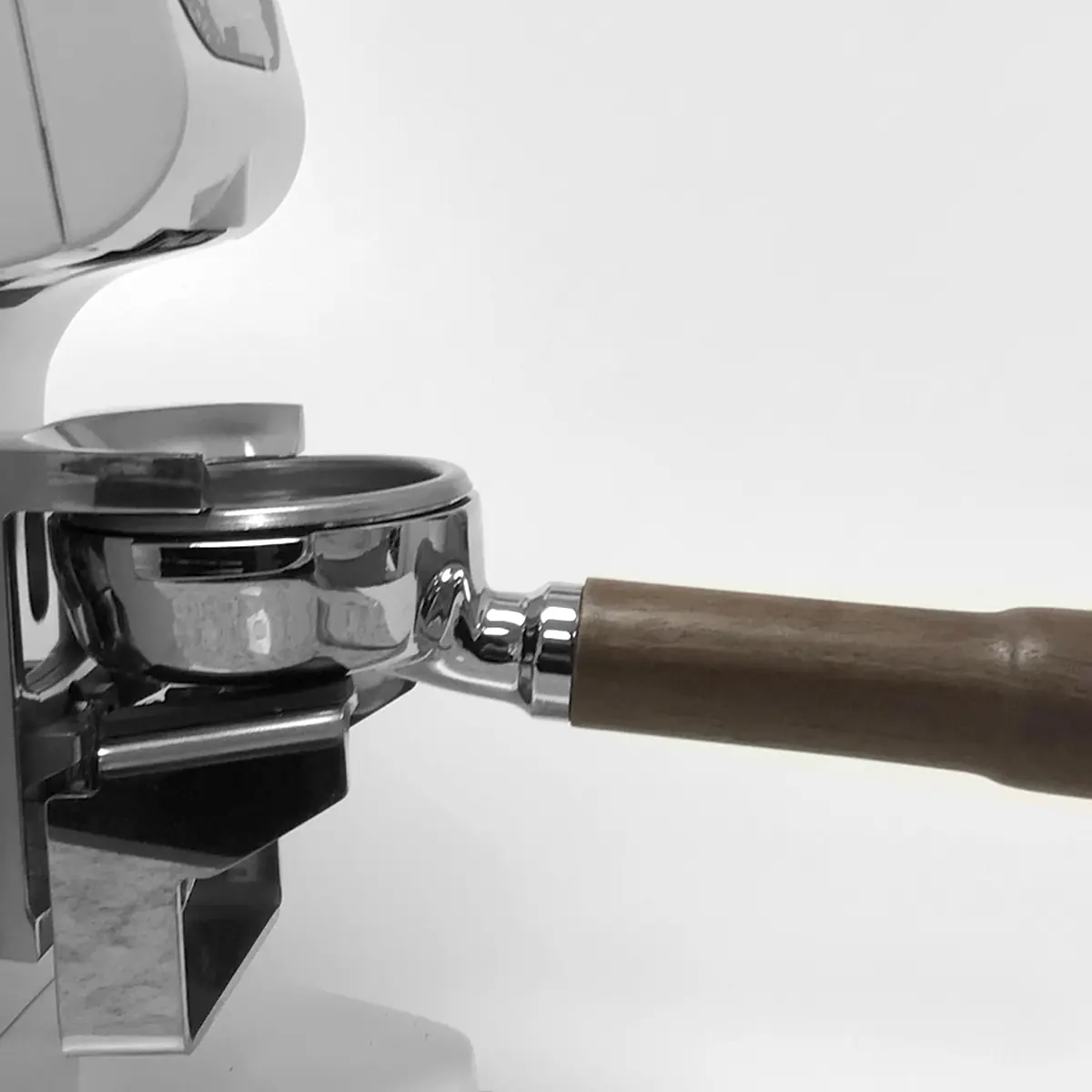 A close-up of a portafilter with a wooden handle on an espresso machine, set against a white background, next to the Eureka Atom W 65 Weight Based Espresso Coffee Grinder. © 2025 1st-line.com