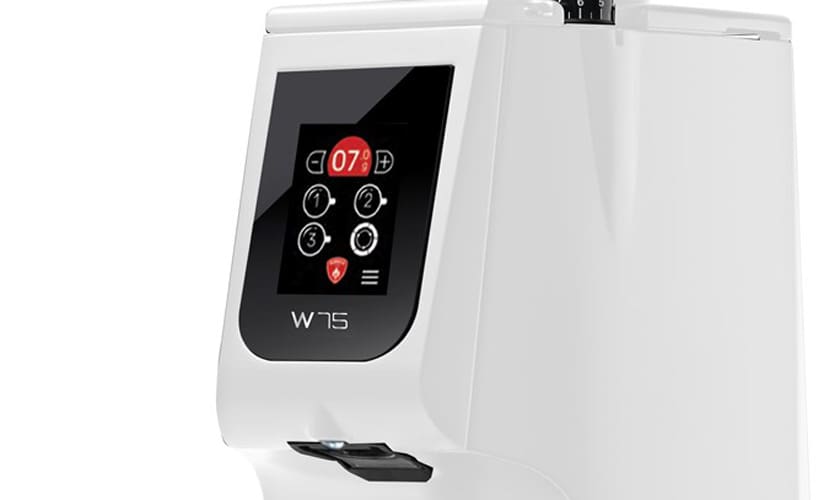 A close-up of the Eureka Atom W 75 Weight Based Espresso Coffee Grinder, featuring a modern white body, black touchscreen display with digital buttons, red “07” indicator, and a sleek, minimalist design. © 2025 1st-line.com