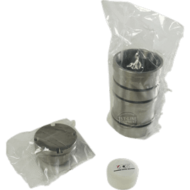 An ACS VES178 Standard Sleeve Kit, featuring a stainless steel coffee tamper and portafilter basket wrapped in plastic, is placed next to a small white container on a plain background. © 2025 1st-line.com