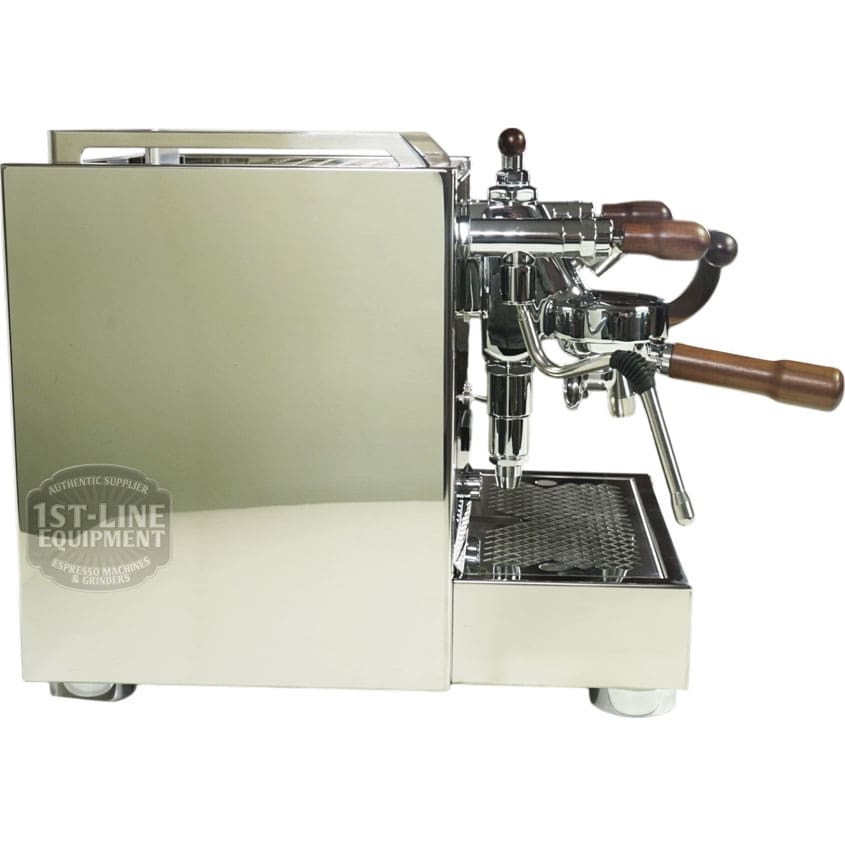 The Torre Peppina EVO Premium V2 Dual Boiler Espresso Machine w/ FC features a stainless steel, polished finish, wooden handles, and multiple levers and spouts; its sleek side view reflects its surroundings. © 2025 1st-line.com
