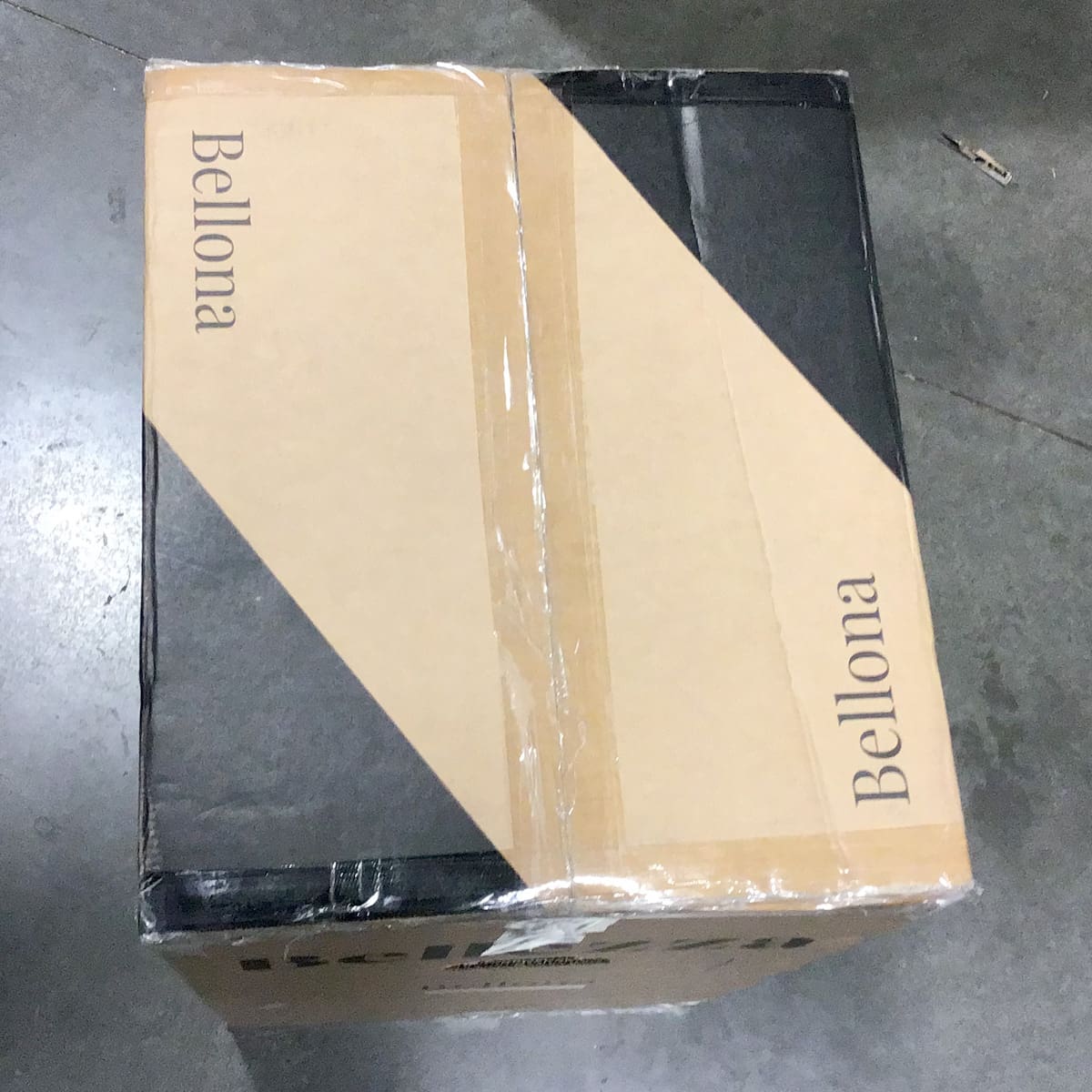 A sealed packing box with the brand name “Bellona” printed on two sides rests on a gray concrete floor. © 2025 1st-line.com