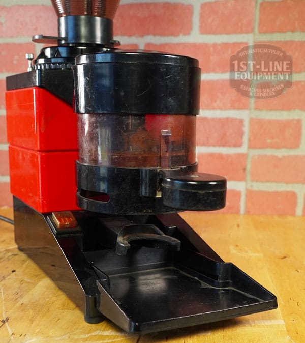 The SIDEWALK SALE - Cunill Doser Grinder (E012) stands out in bold red and black with a clear bean hopper and front tray for collecting fresh grounds—perfect for your next sidewalk sale display. © 2025 1st-line.com