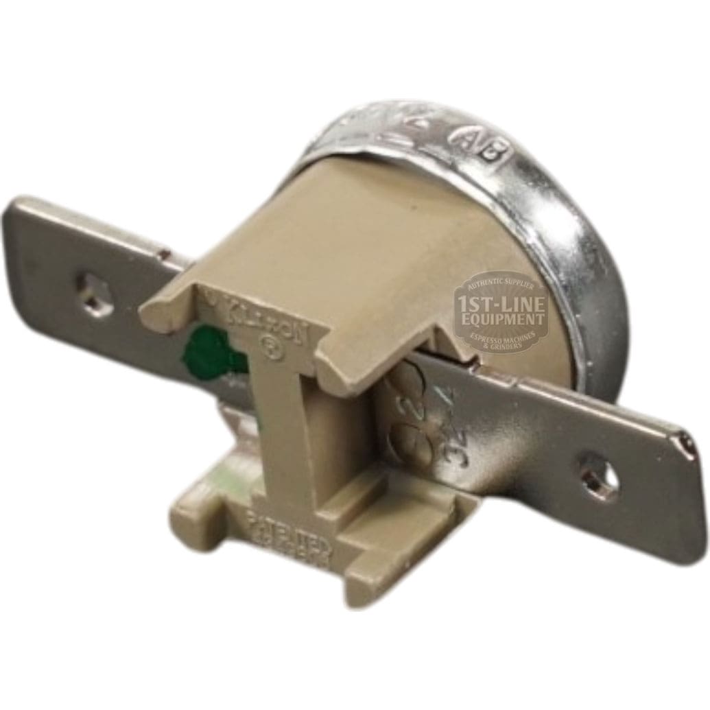 The Bunn 29329.1000 Limit Thermostat Kit is beige and silver, with metal mounting brackets on both sides and a circular back marked with text. © 2025 1st-line.com