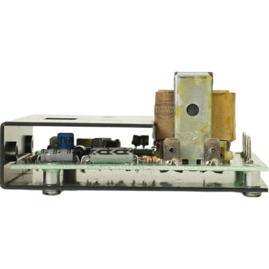 A close-up of the Cecilware L296A Liquid Level Control LCW-S1399-120s circuit board shows capacitors, resistors, and a metal-cased transformer mounted on a rectangular platform. © 2025 1st-line.com