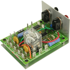 A green circuit board with components like a clear relay, capacitors, resistors, connectors, and a metal heatsink on two black transistors—part of the American Metal Ware 530-007 Solid State Brew Timer. © 2025 1st-line.com
