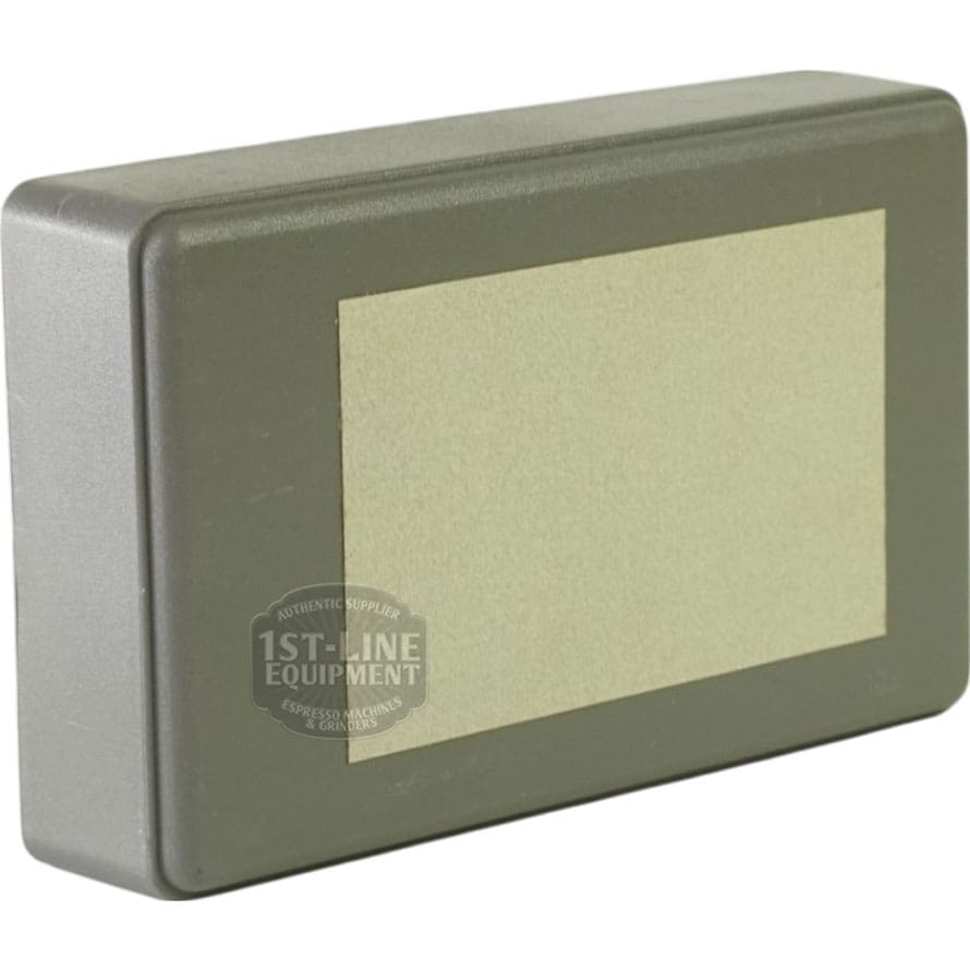 A rectangular gray plastic box labeled as Adapter 011854 for Machine CEE-86, with a blank beige label on one side, is photographed against a white background. © 2025 1st-line.com