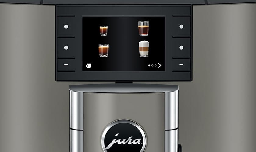 Close-up of the Jura X10 Super-Automatic Espresso Machine’s display shows four coffee drink options with images, side buttons, and the Jura logo beneath the screen. © 2025 1st-line.com