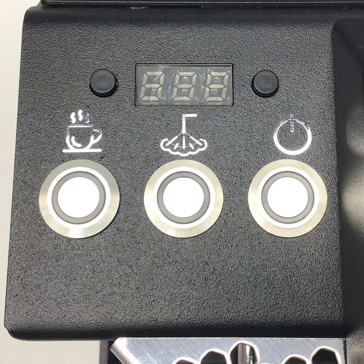 Close-up of the Nurri R-Type DB Espresso Machine control panel with three buttons—cup icon left, steam icon center, power icon right—and a digital display above them. © 2025 1st-line.com