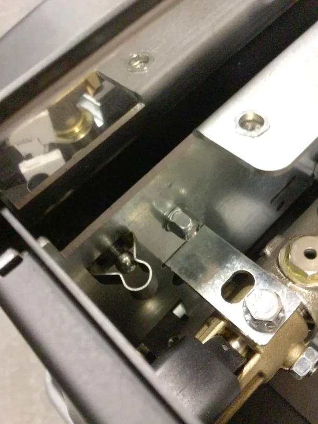 Close-up view of metal mechanical components in a Carimali Bubble machine, featuring bolts, screws, and reflective surfaces, with intricate metal parts—like the Swap Triac—assembled together. © 2025 1st-line.com