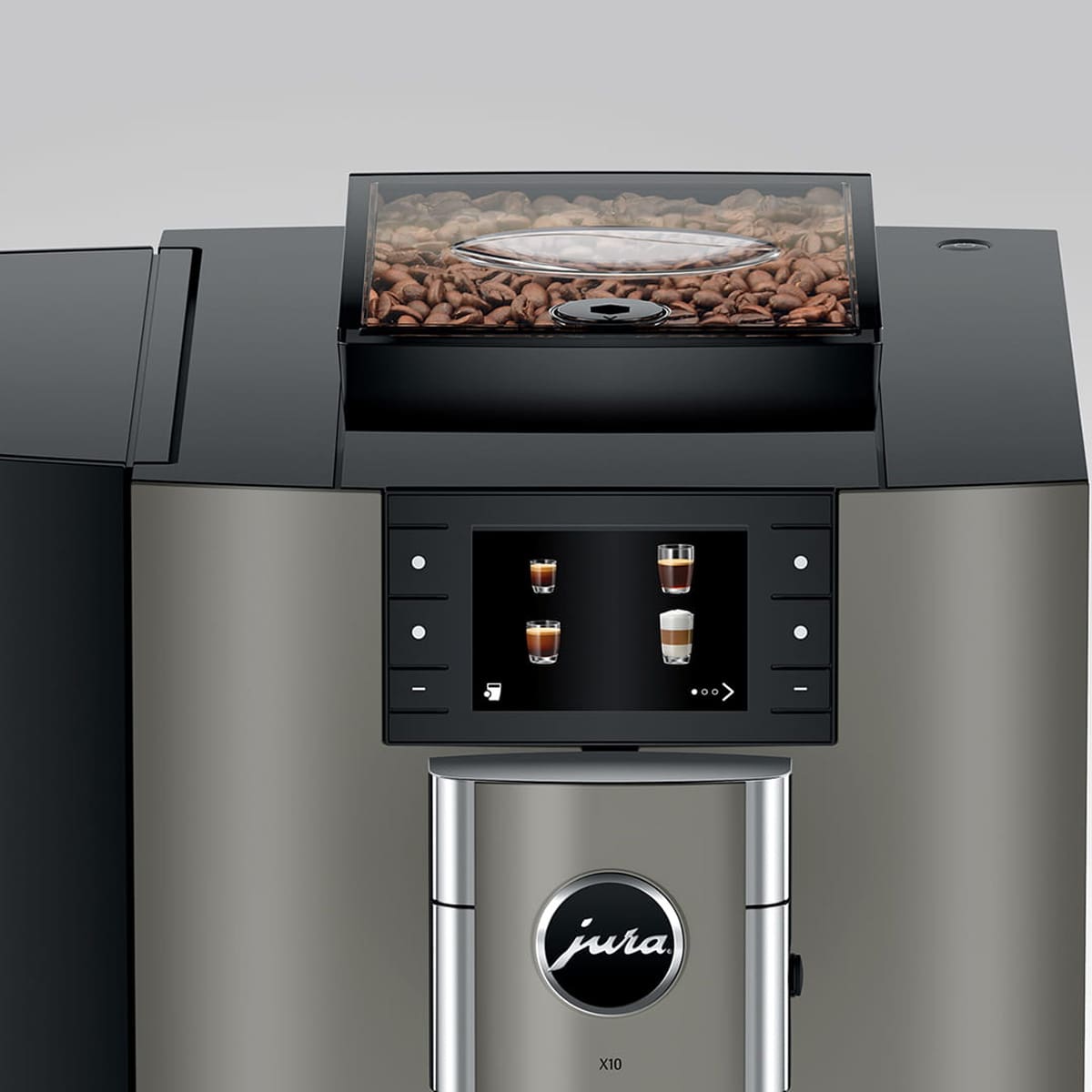 The Jura X10 Super-Automatic Espresso Machine features a transparent bean hopper loaded with coffee beans, a digital drink selection display, and a sleek metallic finish for modern style. © 2025 1st-line.com