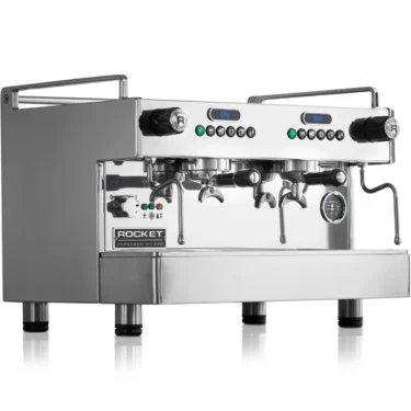 A shiny, stainless steel commercial espresso machine with two group heads, multiple knobs, gauges, and a side steam wand, displaying the Rocket Espresso Milano logo on the front. © 2025 1st-line.com